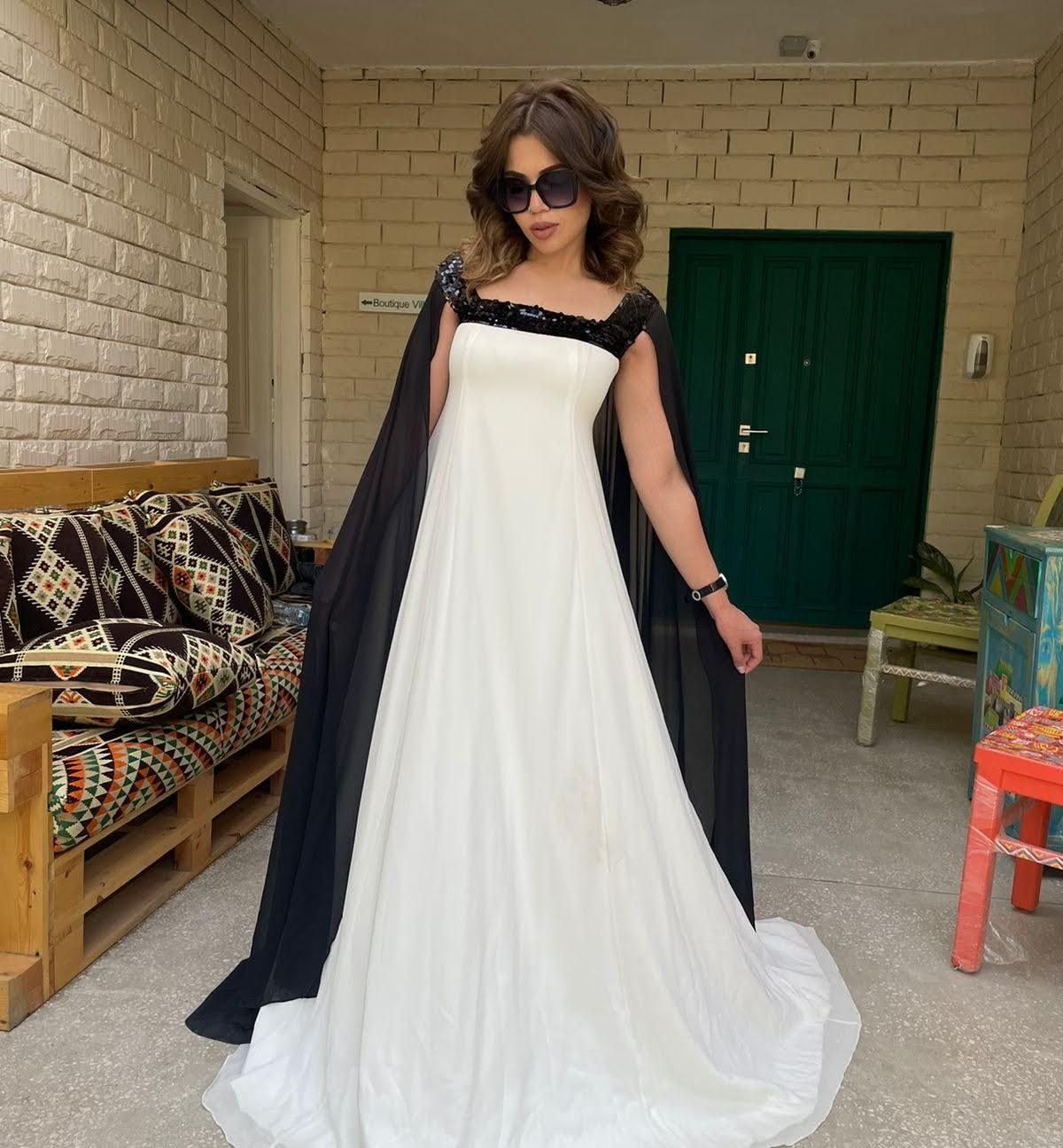 Reehan - Trapeze caped dress